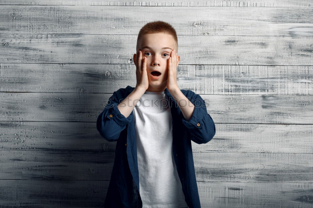 Similar – Boy making face with hands on seat