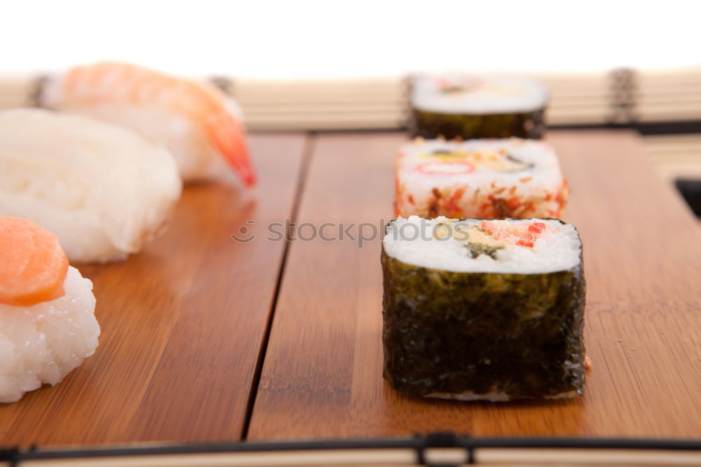 Similar – Female chef placing japanese sushi rolls on a tray