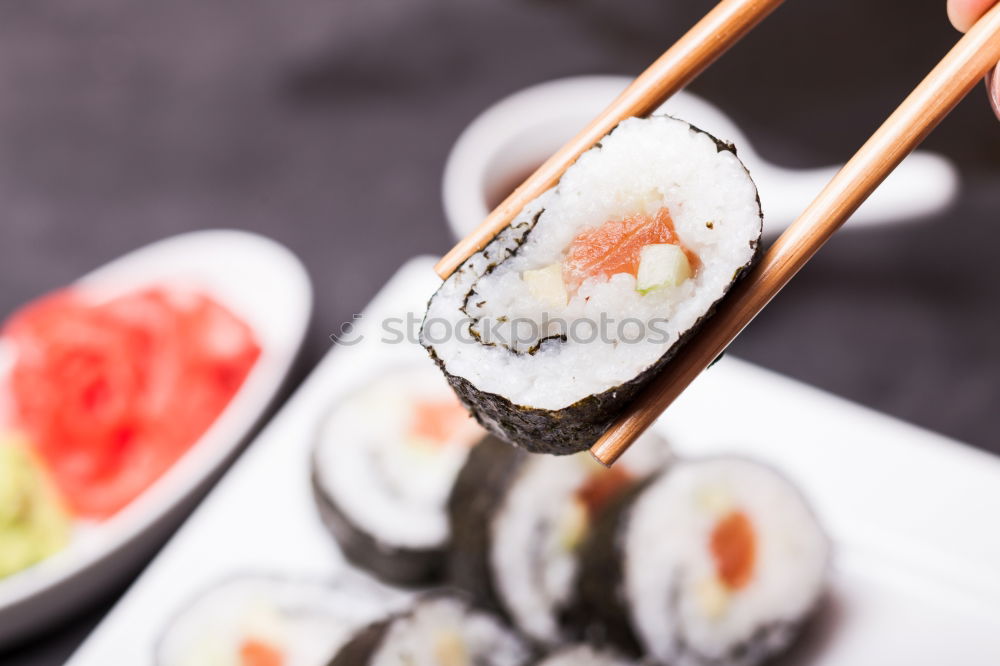 Similar – Female chef placing japanese sushi rolls on a tray