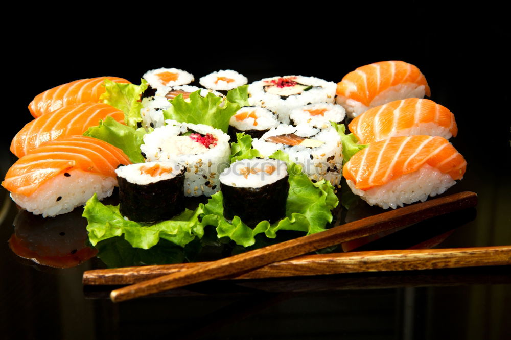 Similar – Japanese food: maki and nigiri sushi set on black background.