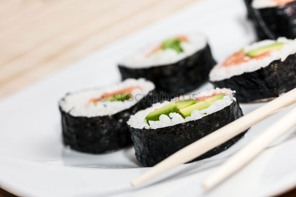 Similar – Female chef placing japanese sushi rolls on a tray