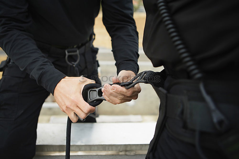 Similar – armed policeman with handcuffs from behind, partial view