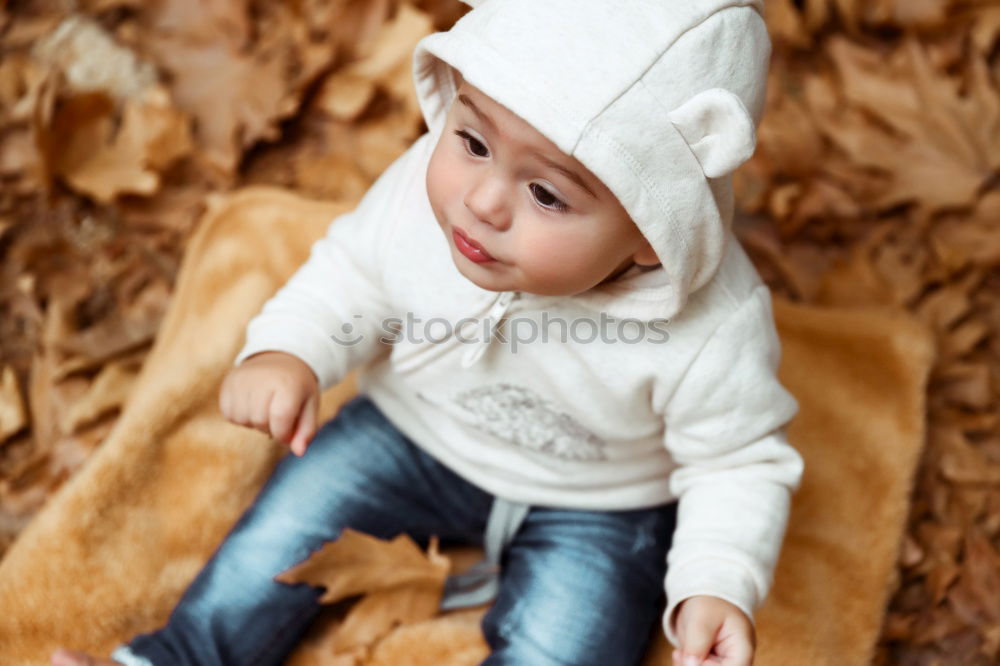 Similar – Little boy with a mibile phone with a wooden door background