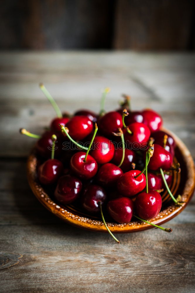 Similar – Sweet cherries in a blue bowl on a dark wooden table