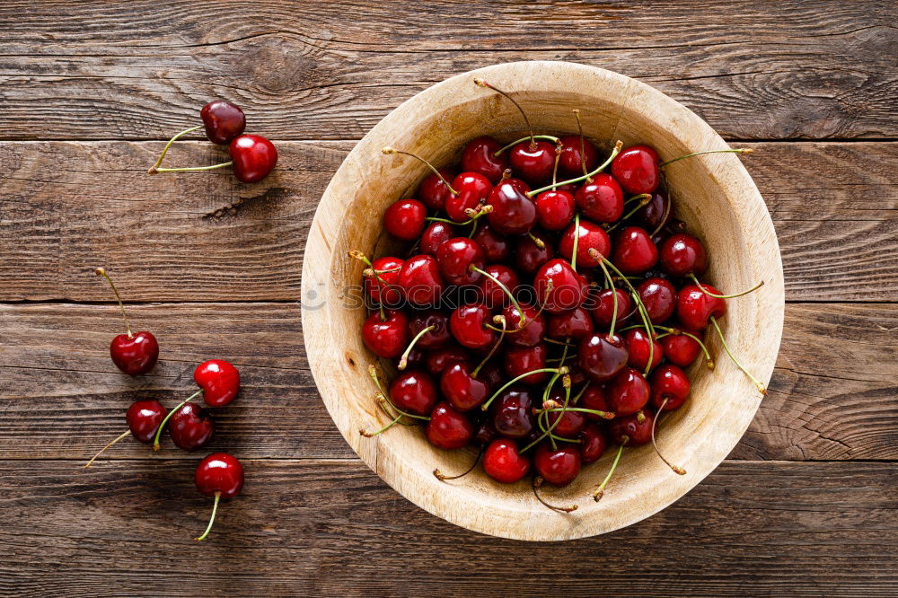 Similar – Sweet cherries in a blue bowl on a dark wooden table