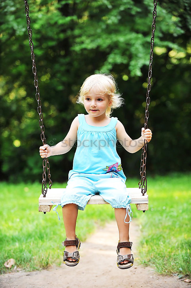 Similar – Little caucasian girl having fun on slide on playground