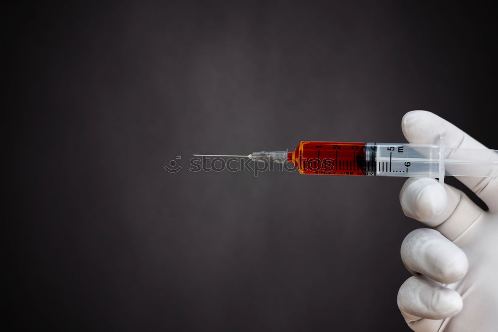 Similar – Small bottle of medicine and syringe on blue background