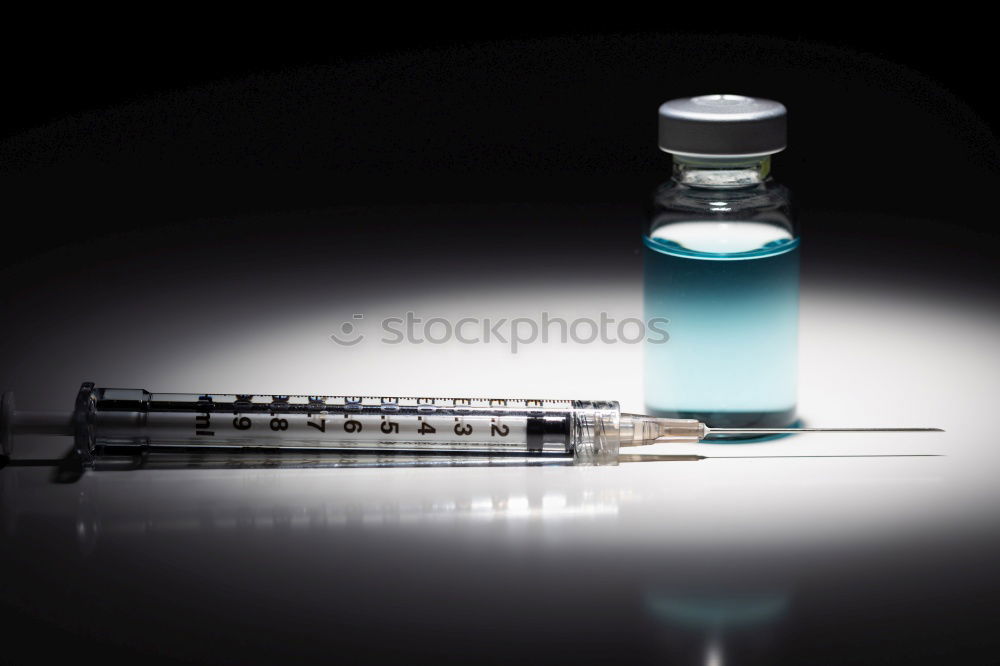 Similar – Small bottle of medicine and syringe on blue background