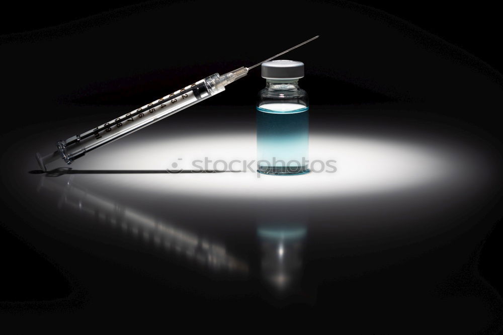 Similar – Small bottle of medicine and syringe on blue background