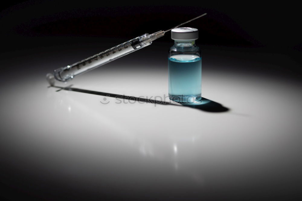 Similar – Small bottle of medicine and syringe on blue background