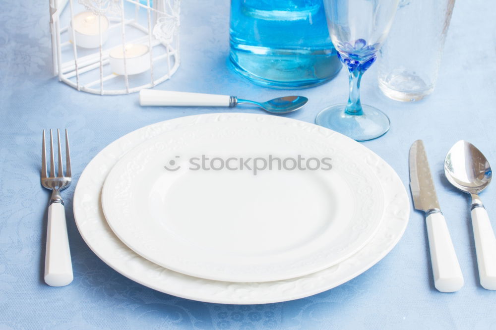 Similar – Crossed knife and fork on an empty white plate