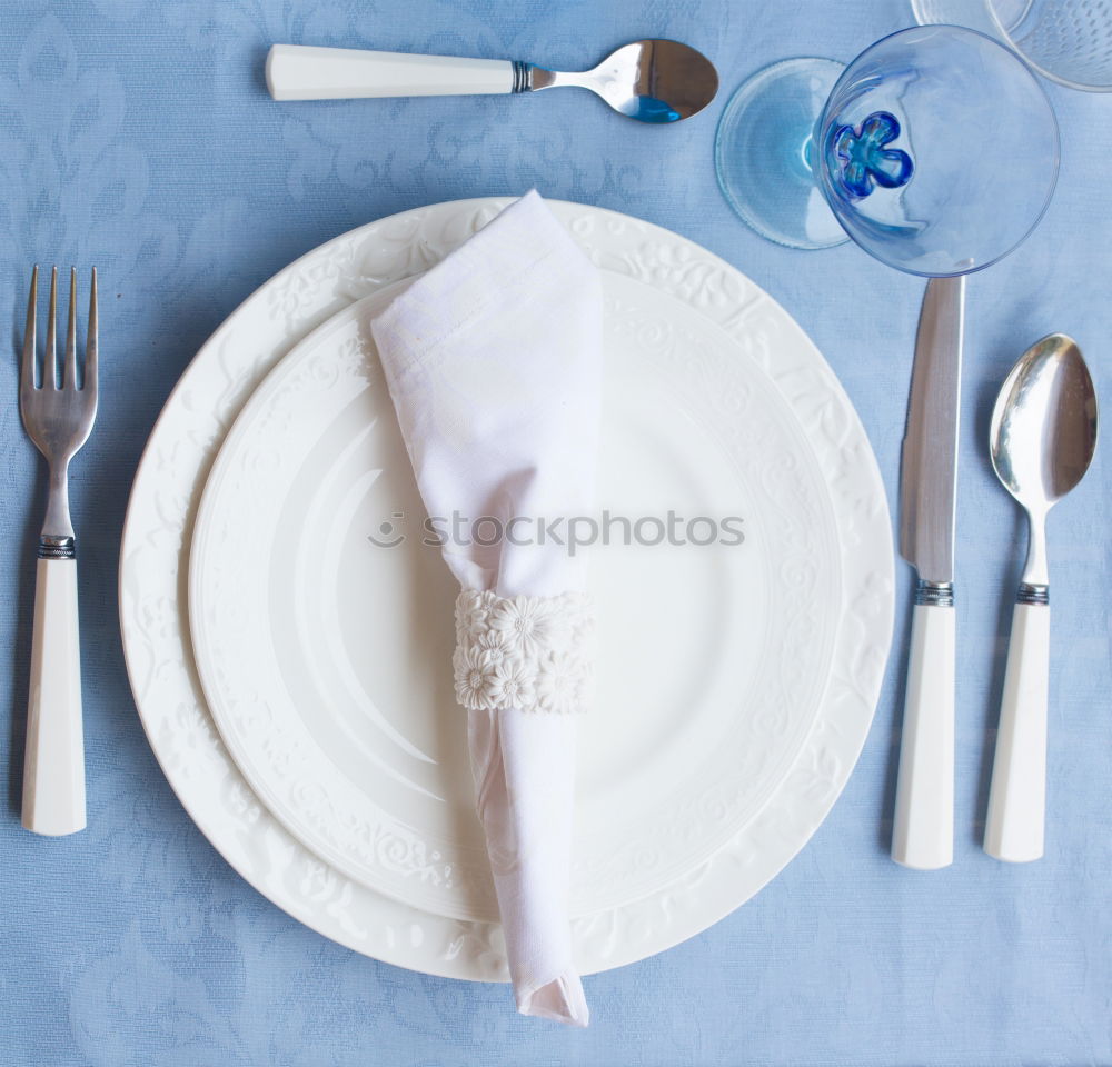 Crossed knife and fork on an empty white plate