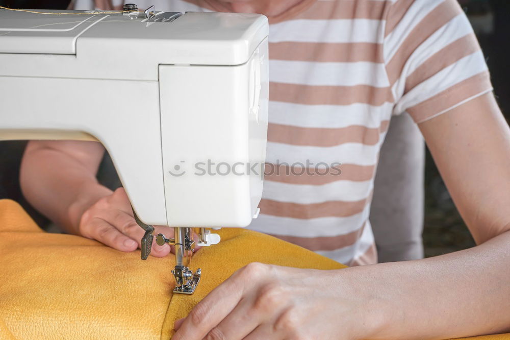 Similar – Women sew on sewing machine