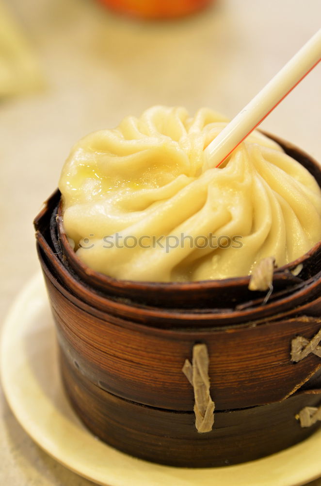 Similar – Dumplings or gyoza served in traditional steamer