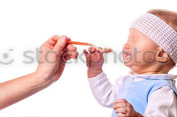 Similar – Daddy feeding toddler a spoonful of baby food