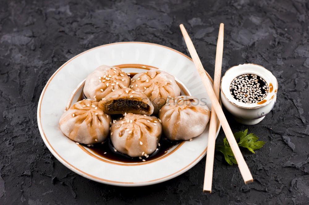 Similar – Dumplings or gyoza served in traditional steamer