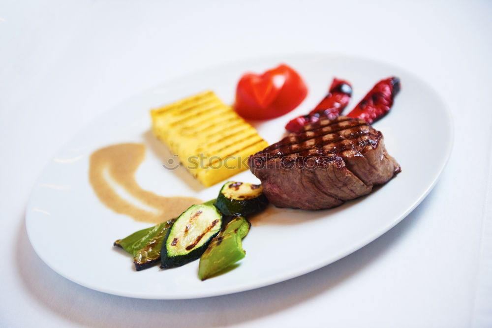 Similar – dinner with beef on a pure white dinner plate