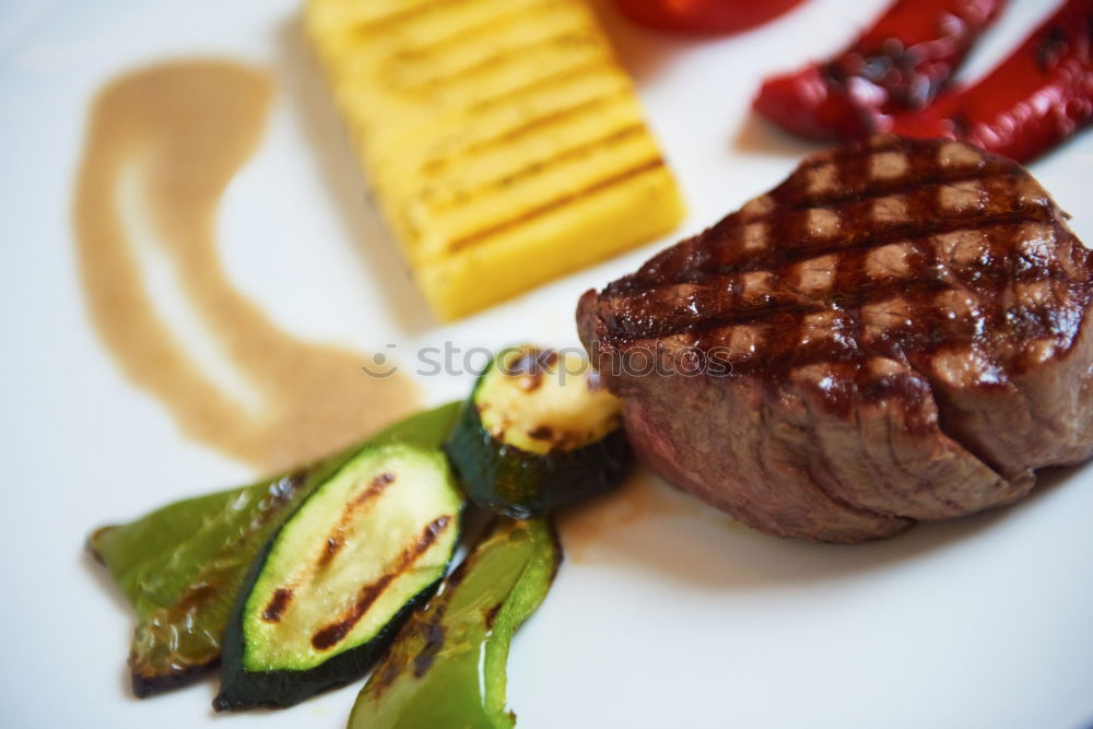 Similar – dinner with beef on a pure white dinner plate