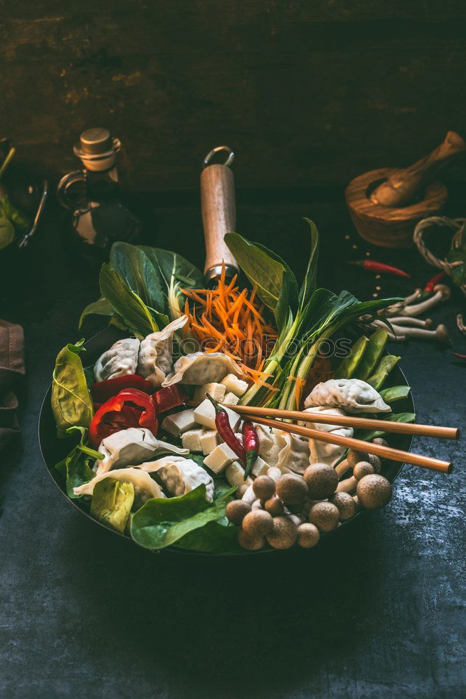 Similar – Asian food background with wok pan with vegetarian  korean hot pot and chopsticks on dark rustic kitchen table background, top view. Copy space.