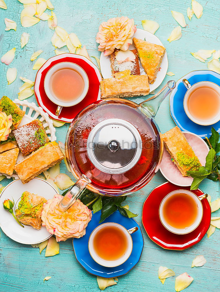 tea break with cups, flowers, cake and teapot