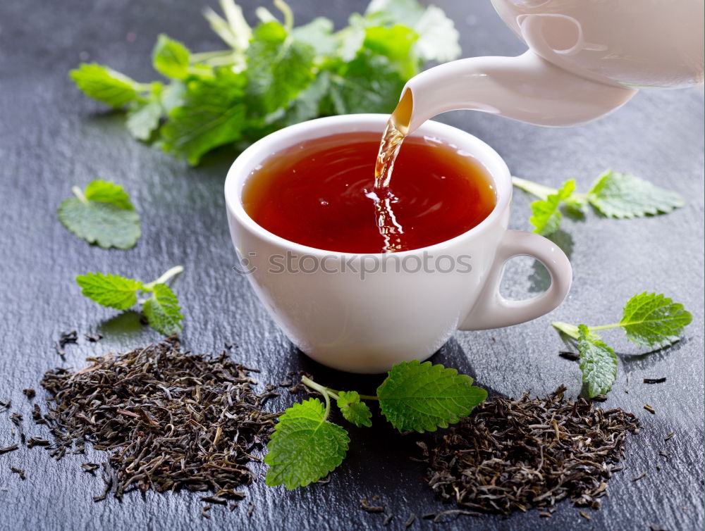 Similar – Black tea in a white cup and saucer and jasmine flowers