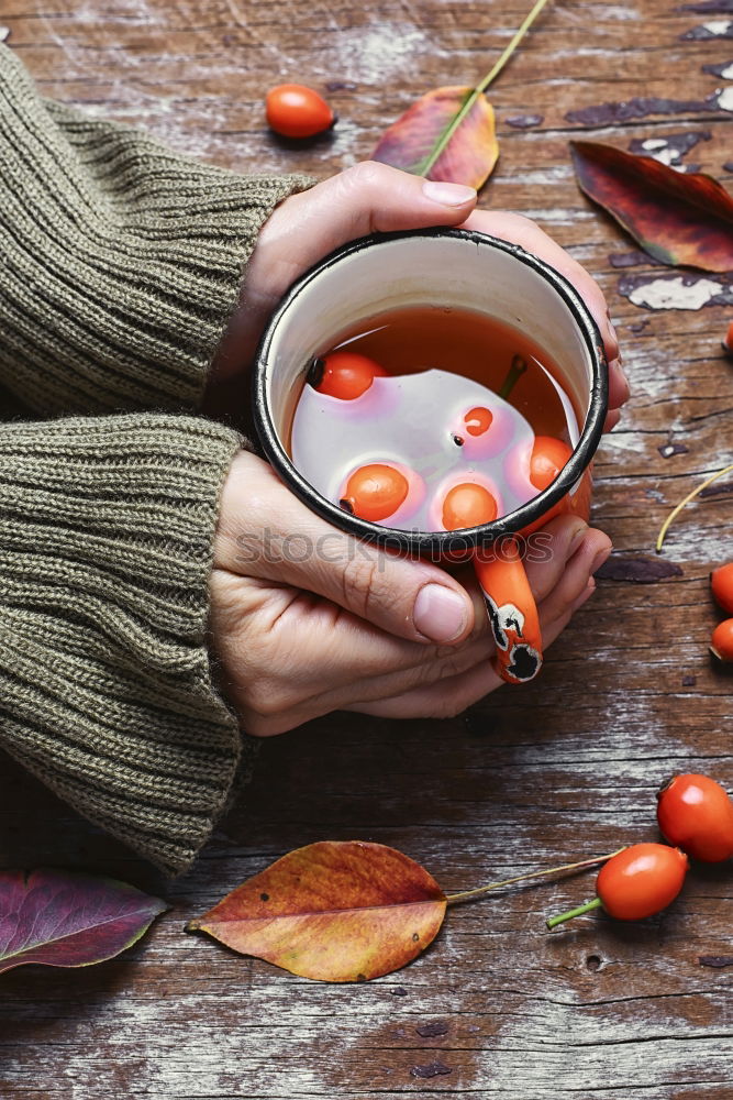 Similar – female hands holding an iron mug with carrot juice