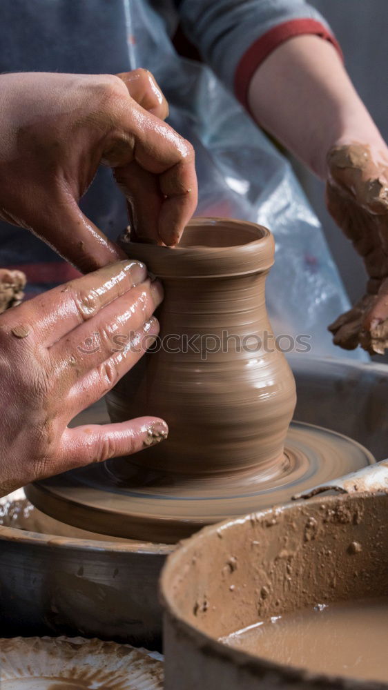 Potter makes clay bottle