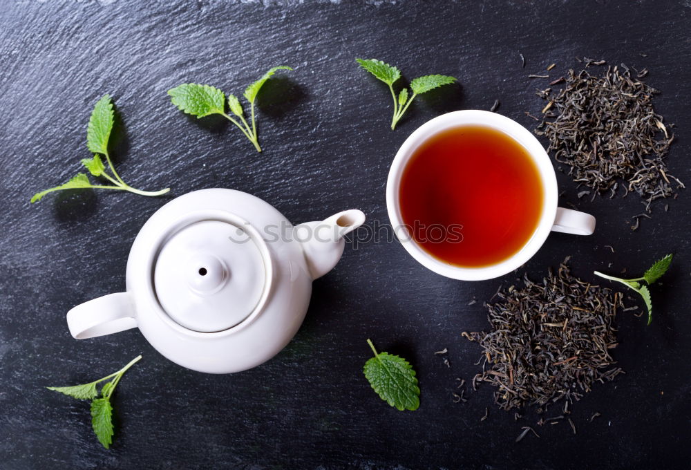 Similar – Black tea with jasmine in a white cup on a brown wooden table