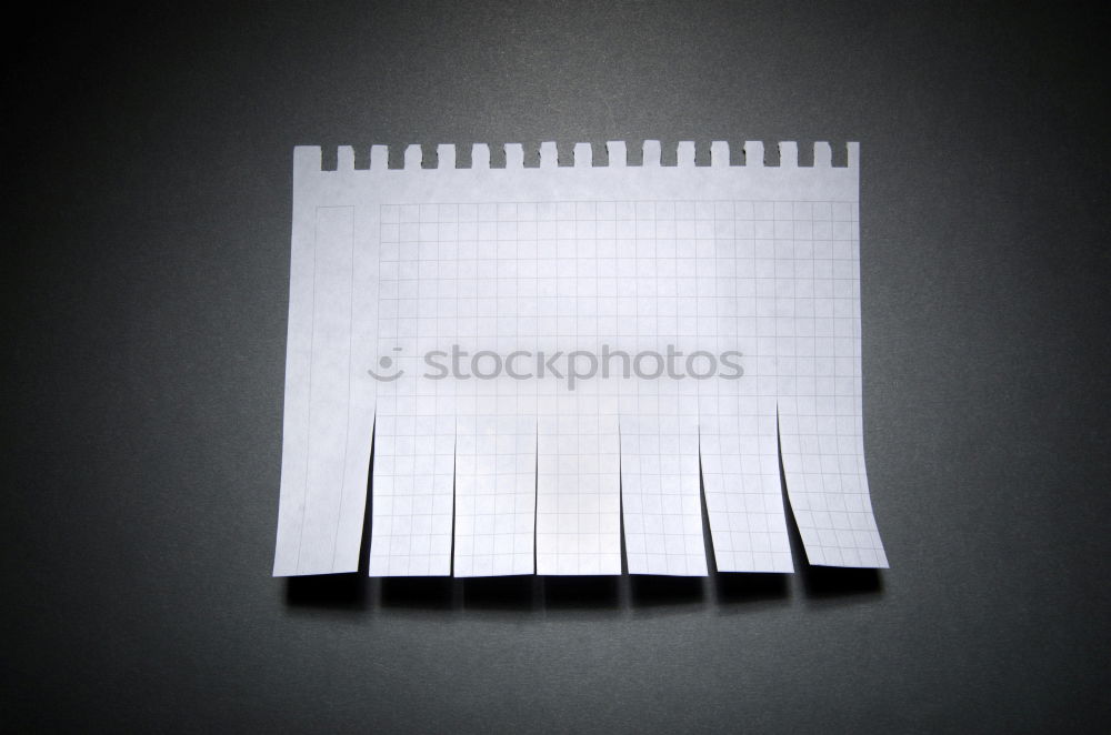 Lined notebook with spiral, pencil and a crumpled piece of paper on an old wooden table