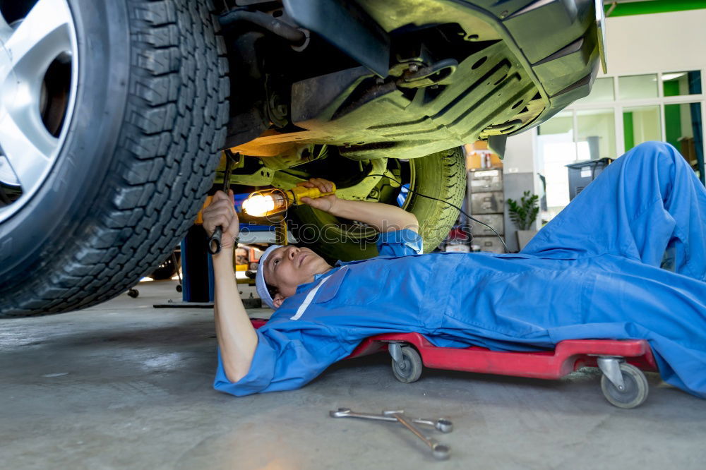 Similar – Professional Mechanic Repairing Car.