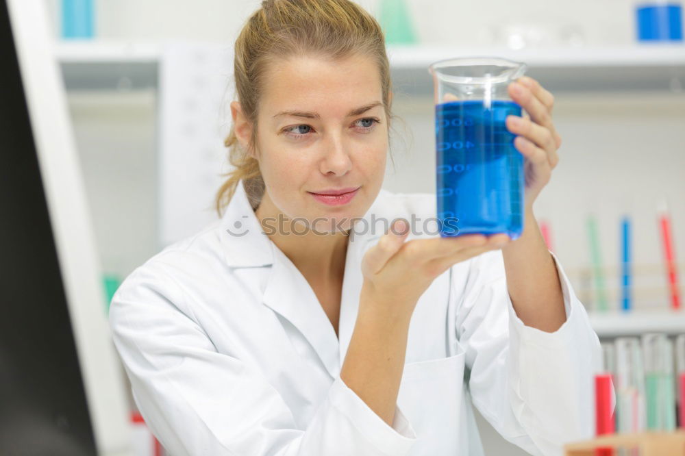 Similar – Image, Stock Photo Woman holding flask in lab