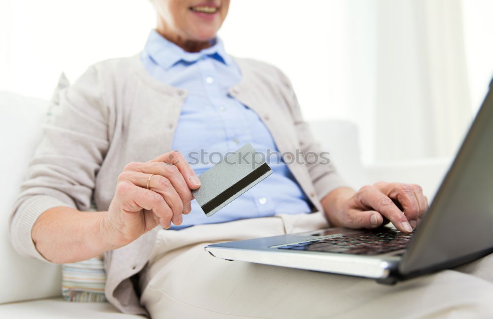 Two businessman meeting and using smartphone with laptop at outdoor cafe