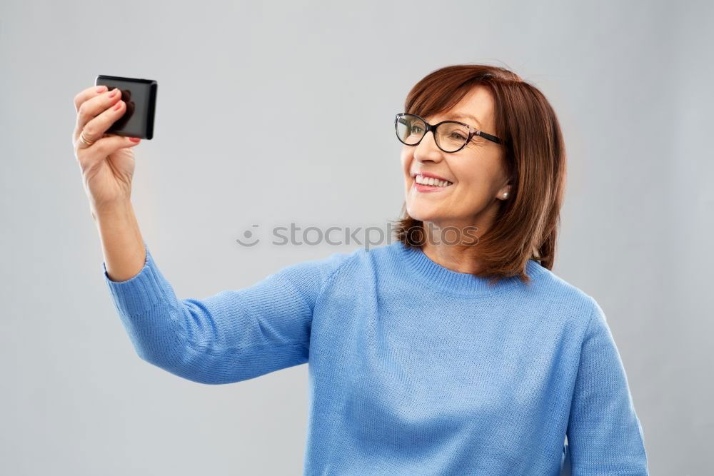 Similar – mature woman taking a selfie with smartphone