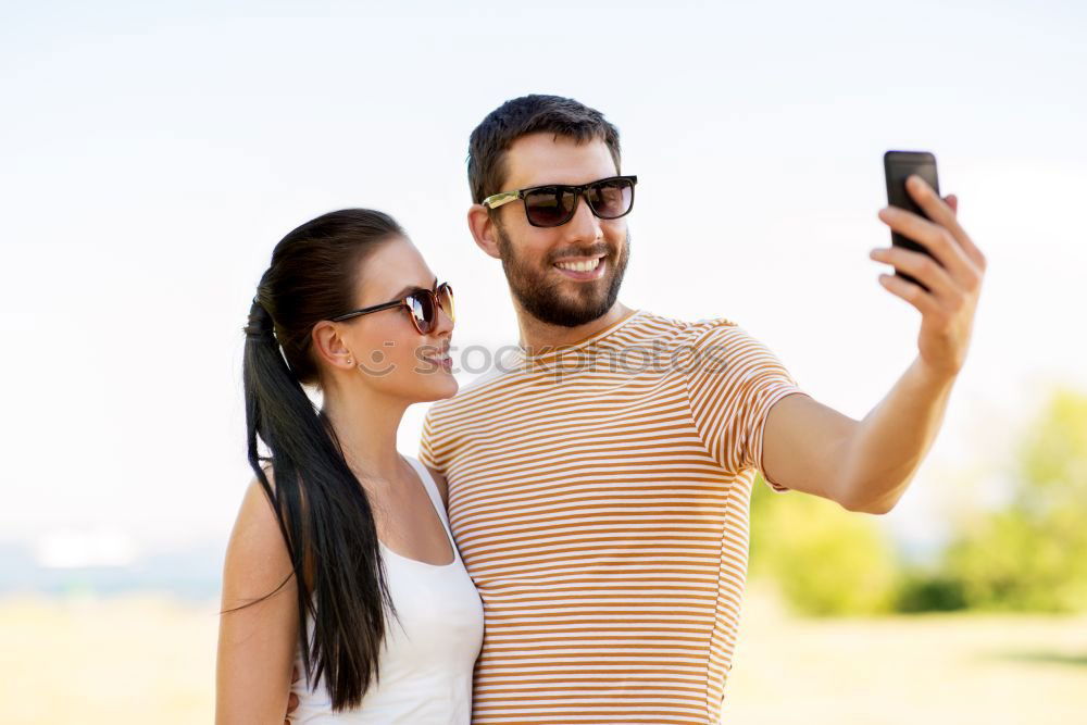 Similar – Image, Stock Photo Romantic Young Couple taking a photo with mobile phone.