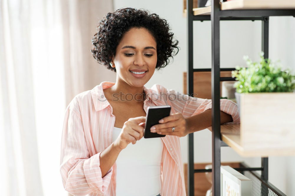 Similar – smiling young woman typing a message on cellphone