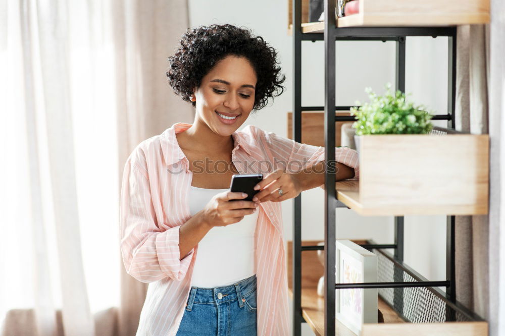 Similar – smiling young woman typing a message on cellphone