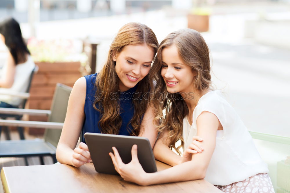 Similar – Image, Stock Photo Two male teenagers surfing the internet on tablet computer while sitting in cafe. One young man pointing at screen