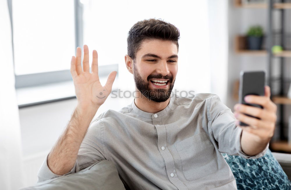Similar – Image, Stock Photo Young smiling man looking at his smartphone in the street