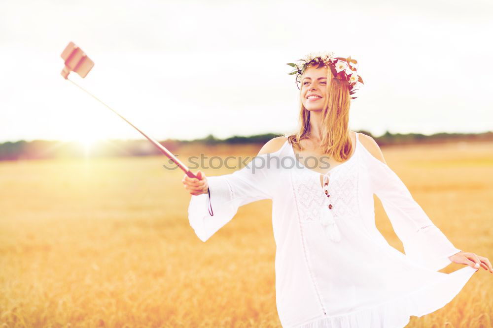 Similar – Image, Stock Photo Hand holding a cowboy hat over a field of wheat