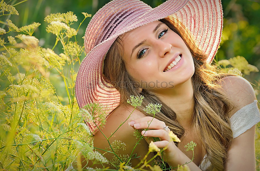 romantic portrait of happy child girl picking bouquet of beautiful blue delphinium flowers from summer garden