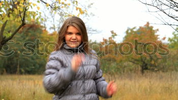 Similar – Young woman in grey sweater is standing in a clearing in the woods