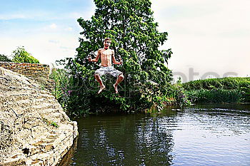 Similar – Image, Stock Photo Bathing fun at the quarry pond. Young naked man jumps joyfully into the water