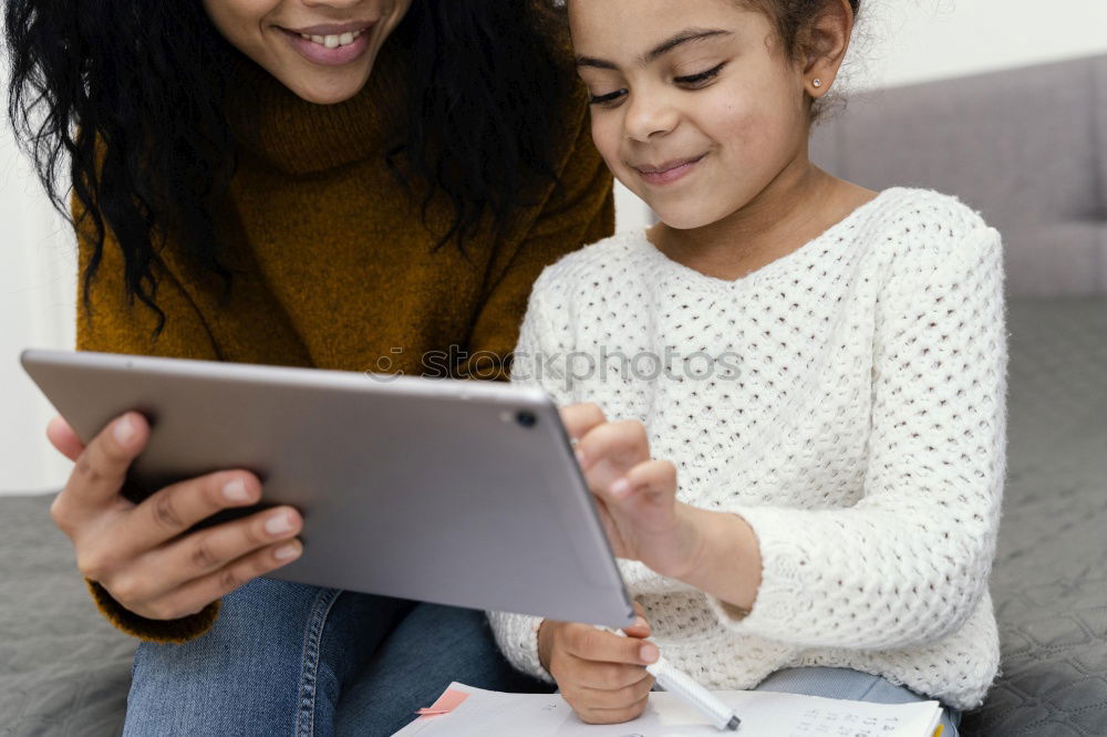 Similar – Mother and her child with digital tablet.