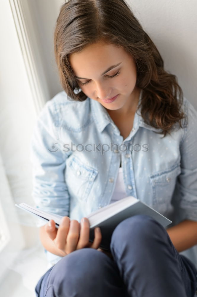 Similar – Young woman sitting on floor with notepad