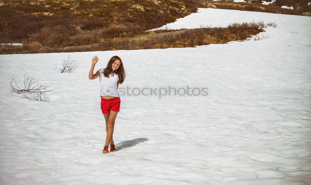 Similar – Image, Stock Photo A woman is standing in the snow.  Next to her two empty footprints. She wears black and white striped stockings and purple boots.