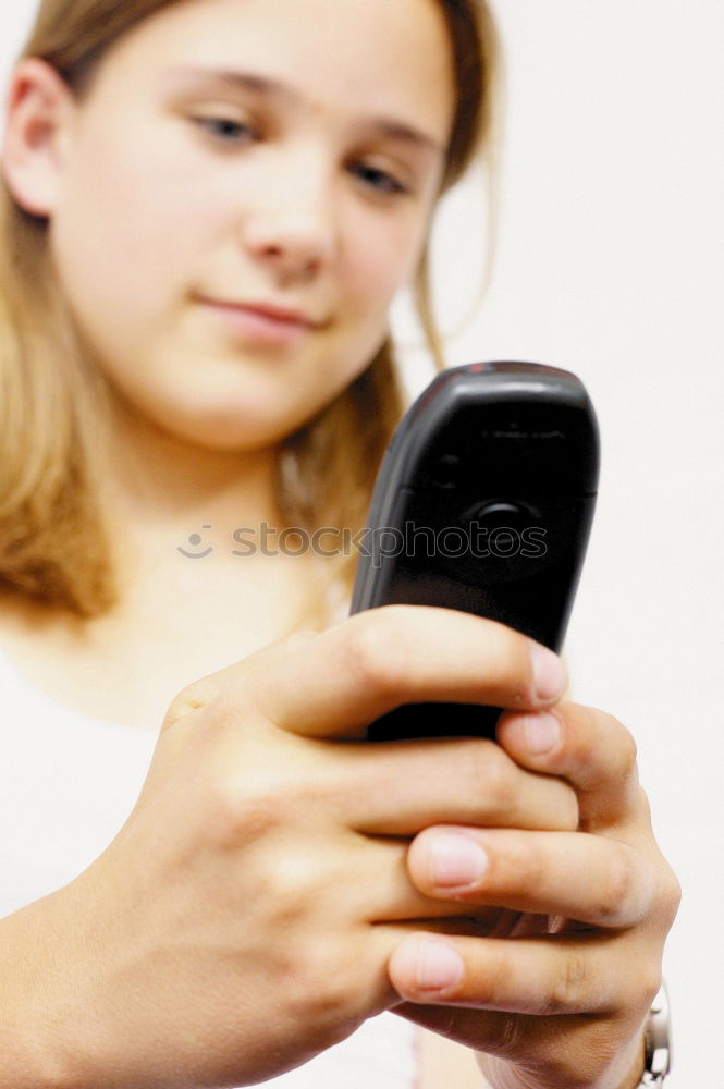 Similar – portrait of a beautiful kid using mobile phone