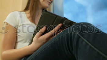 Similar – Young woman sitting on floor with notepad