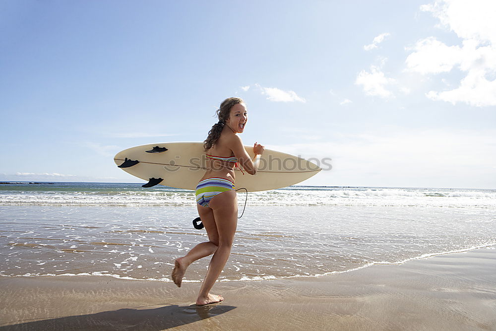 Similar – Image, Stock Photo Beautiful Surfer Girl standing on the Beach