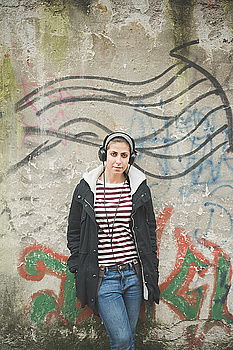 Similar – Image, Stock Photo Young short hair woman in urban environment and graffiti