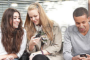 Similar – Multi-ethnic group of young people using smartphone